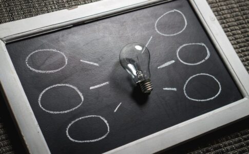 clear light bulb on black surface